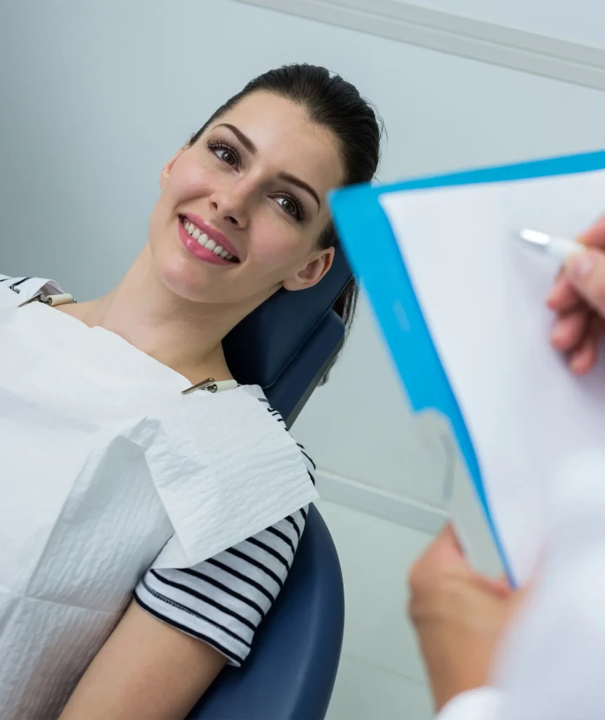 Dentist recording findings during a gum disease assessment consultation with a patient