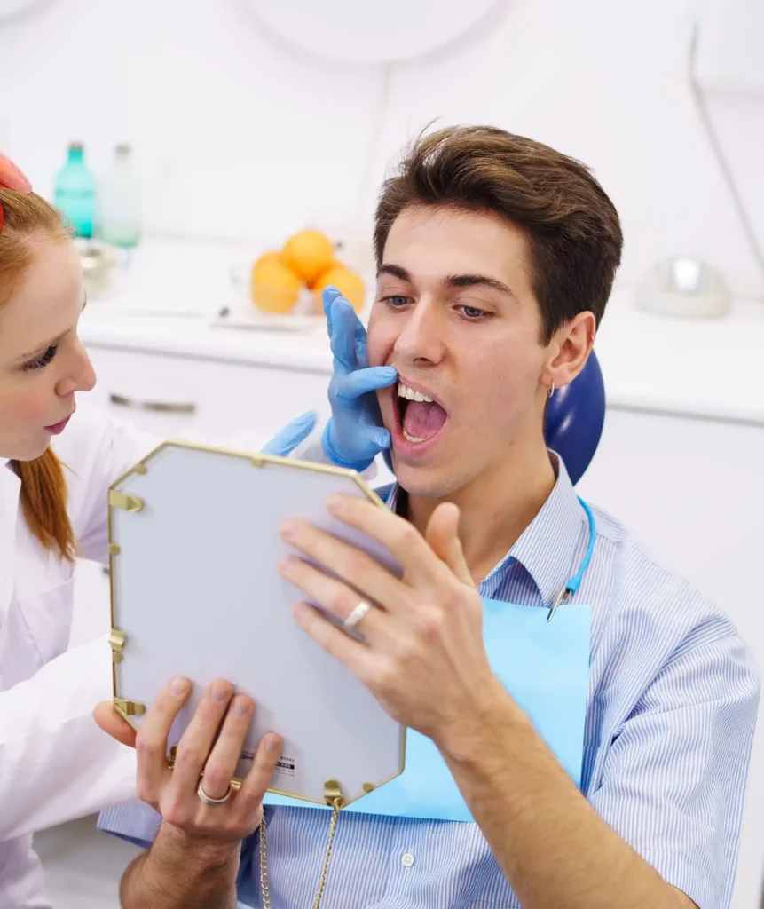 Dentist examining a patient's inner cheek for an unusual soft tissue lesion during an oral assessment
