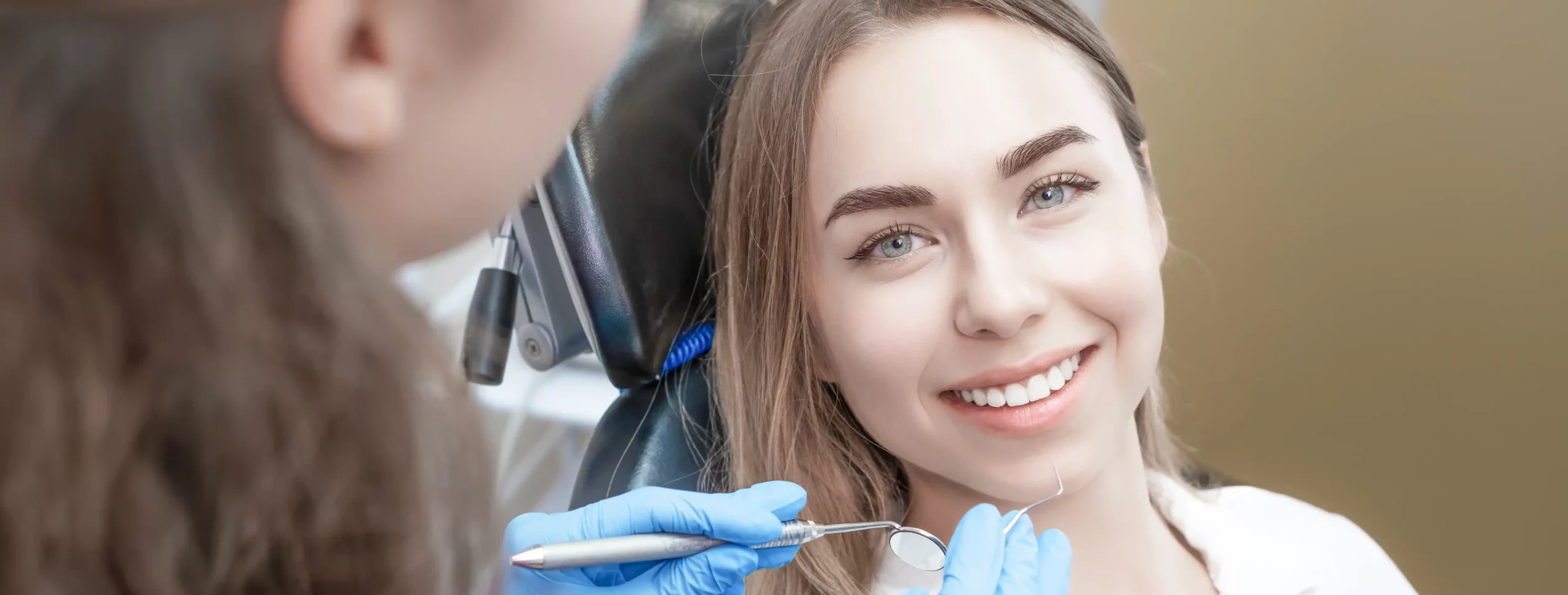 Dentist assessing a patient's smile and gum line during a gummy smile correction consultation