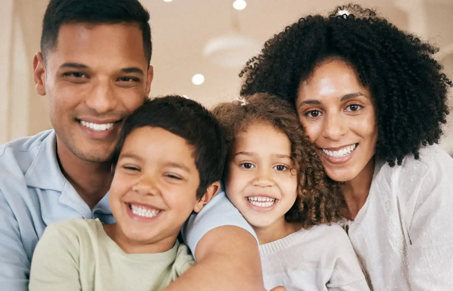 Happy family smiling together showcasing healthy dental care services
